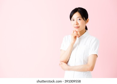 portrait of asian nurse isolated on pink background - Shutterstock ID 391009558