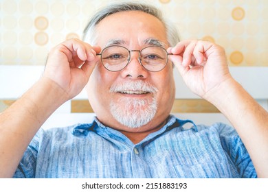 Portrait Asian Old Elderly Man Expression Happy Wearing Glasses To Read A Book.