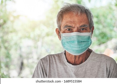 Portrait of Asian old man, in a face medical mask. pandemic coronavirus disease on blurred background. Covid-19 outbreak contamination concept. - Powered by Shutterstock