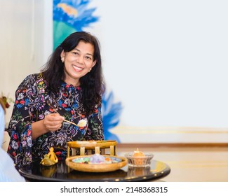Portrait Of Asian Old Woman 60s Smile Eating Thai Dessert In Restaurant.Senior 60 Mother Woman.Senior Adult Woman Smiling Happy With Retirement Life.Dental Care.Unaltered.Indian Or Mexican.Food People