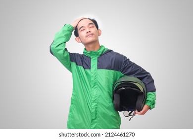 Portrait Of Asian Online Taxi Driver Wearing Green Jacket Straightening His Hair And Holding Helmet. Isolated Image On White Background