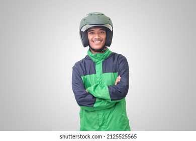 Portrait Of Asian Online Taxi Driver Wearing Green Jacket And Helmet, Standing With Crossed Arms. Isolated Image On White Background