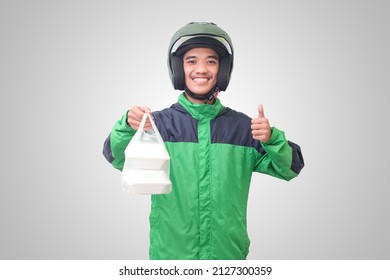 Portrait Of Asian Online Taxi Driver Wearing Green Jacket And Helmet Holding Food Wrapped In Foam Plastic Box. Isolated Image On White Background