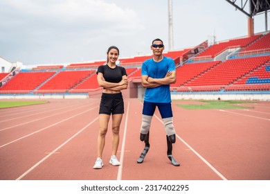 Portrait of Asian para-athlete disabled and trainer standing in stadium. Attractive amputee male runner and young sportswoman smiling, looking at camera after practicing for Paralympics competition. - Powered by Shutterstock