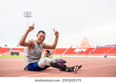 Portrait of Asian para-athletes disabled with prosthetic in stadium. Attractive amputee male runner looking at camera after practicing for Paralympics competition regardless of physical limitations.
 - Powered by Shutterstock