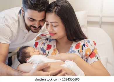 Portrait of Asian parents newborn baby day, Closeup portrait of asian young couple father mother holding new born baby in hospital bed. Happy asia lovely family, nursery breastfeeding mother’s day