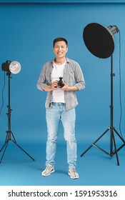 Portrait Of Asian Photographer On Color Background