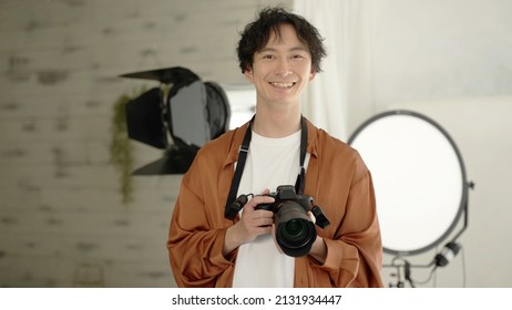 Portrait Of Asian Photographer In The Photo Studio