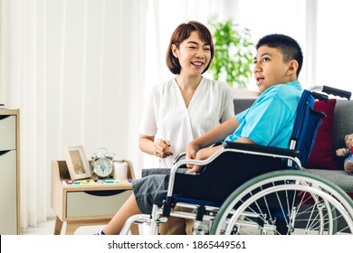 Portrait of asian physiotherapist carer helping and playing with special disabled child health problem by doing exercises sitting in wheelchair in rehabilitation clinic.disability care concept - Powered by Shutterstock