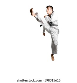 Portrait of an asian professional taekwondo black belt degree (Dan) jumping for kick. Isolated full length on white background with copy space and clipping path - Shutterstock ID 598315616