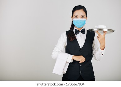 Portrait Of Asian Restaurant Waitress In Medical Mask Serving Food