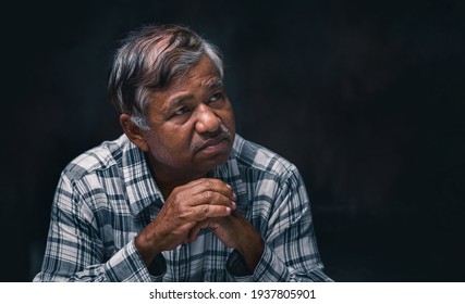 Portrait Of Asian Sad Senior Man In Studio Shot On Black Background.