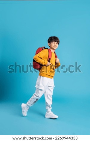 Portrait of Asian school boy born on a blue background