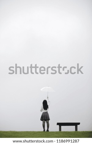 person with umbrella on rainy day