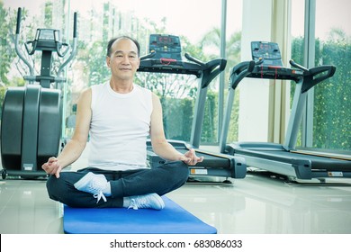 Portrait Of Asian Senior Elderly Sport Ware Man Doing Yoga Moves Or Meditating At The Gym. Health Care And Medical Concept
