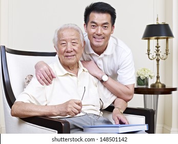 portrait of an asian senior and his adult son.
