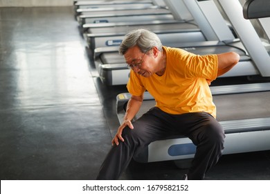 Portrait Asian Senior Man Is Low Back Pain After Running Treadmill In Fitness Gym