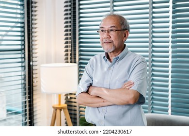 Portrait Of Asian Senior Older Man Standing With Arms Crossed In Living Room With Copy Space, Happy Life Retirement And Healthcare Concept