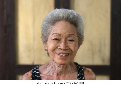 Portrait Of Asian Senior Retirement Woman Smile Wrinkles With Casual Clothing Standing In Home Happy Lifestyle. Elderly Grandma. Southeast Asia Ethnicity Good Healthy. Retro Style Copy Space.