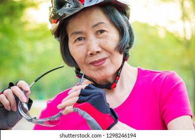 Portrait of asian senior woman wearing helmet. - Powered by Shutterstock