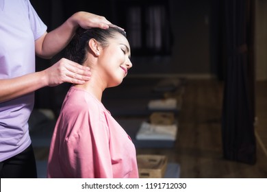 Portrait Of Asian Smile Beautiful Woman Massaging Neck By Professional Massager In Spa Salon. Girl Relax And Body Care Treatment By Thai Massage.