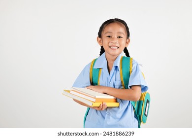 Portrait Asian smiling young girl kids kindergarten hair in pigtails holding backpack hold books studio isolated white background, happy cute little schoolgirl wears school uniform, back to school - Powered by Shutterstock