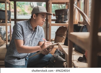 Portrait Of Asian Store Manager Checking The Product