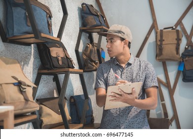 Portrait Of Asian Store Manager Checking The Product