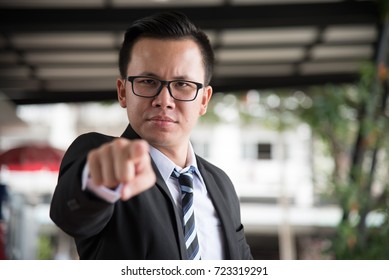 Portrait Of Asian Stress Businessman, 30-40 Years Old, Pointing Finger With Serious Face, Selective Focus