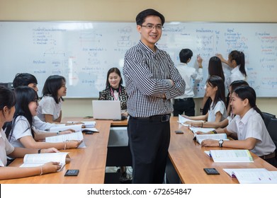 Portrait Of Asian Teacher Standing When Giving Lesson To Group Of College Students In The Classroom, University Education Concept