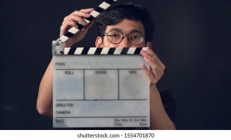 Portrait Of Asian Thai Teen Face With White Film Slate For Filmmaking. Space For Text