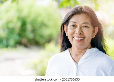 Portrait Of Asian Thai Woman 60s Smile Looking Camera Outdoor.Dentist Dental Care.Insurance Health, Beauty Business.Senior Indian Woman.Old Black Senior Woman Happy Retirement Life.women Old Asian.