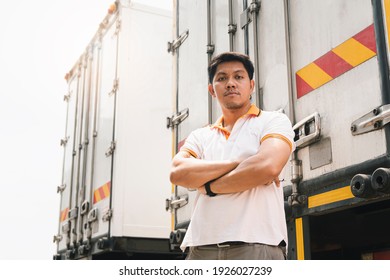 Portrait Of Asian Truck Driver Standing Cross One's Arm With Cargo Trailer Truck.