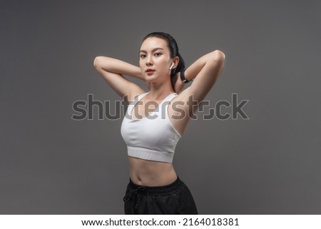 Portrait Asian woman active in sportswear posing in studio. Beautiful female healthy fitness.