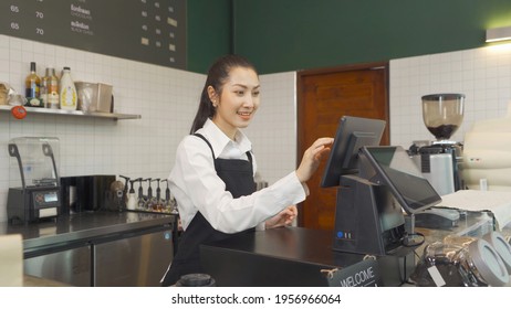 Portrait of Asian woman barista people in apron selling products online via live e-commerce live or conference sales social media, cafe restaurant cashier. waitress in coffee shop. People lifestyle. - Powered by Shutterstock