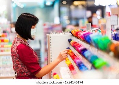 Portrait Of Asian Woman Choosing School Stationery In The Supermarket.