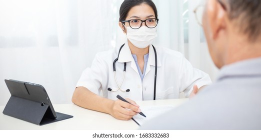 Portrait of asian woman doctor wear protection face mask showing a patient some information on digital tablet clip board, patient listen to specialist doctor in clinic office, medical protect banner
