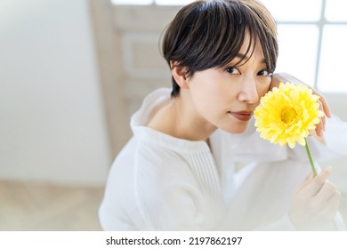 Portrait Of Asian Woman With A Flower.