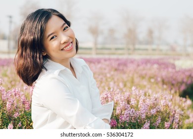 Portrait Asian Woman In The Flowers Garden