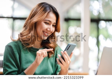 Portrait of an Asian woman holding a smartphone, typing messages, chatting with friends. on social networks mobile application concept Shopping online, browsing the web, ordering food