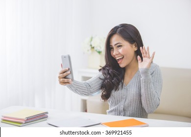 Portrait Of Asian Woman At Home Making A Video Call Using Smart Phone