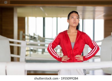 Portrait Of Asian Woman Kick Boxer Thinking At Gym Boxing Ring