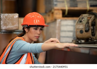 Portrait Of An Asian Woman With Large Machinery Used In Heavy Industrial Plants.