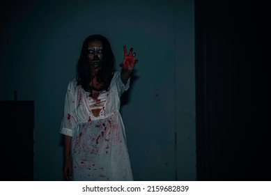 Portrait Of Asian Woman Make Up Ghost Face With Blood,Horror Scene,Scary Background,Halloween Poster,Thailand People