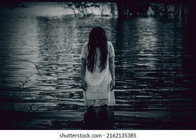 Portrait Of Asian Woman Make Up Ghost Face At The Swamp,Horror In Water Scene,Scary At River,Halloween Poster,Thailand People