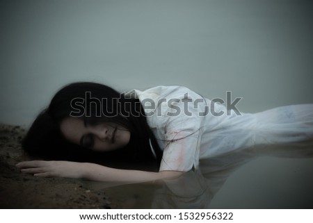 Portrait of asian woman make up ghost face at the swamp,Horror scene,Scary background,Halloween poster,Thailand people