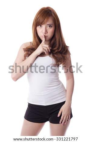 Portrait of asian woman making a hush gesture with finger on lips, isolated on white background.