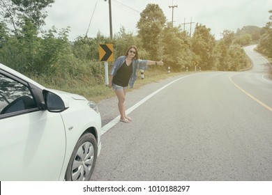 Portrait Of Asian Woman With Short Hair In Jeans Jacket Gesture Ask For Help On The Road Having Problem With A Car While Go To Celebrate A Bachelorette Party. Broken Down Car On The Road. 