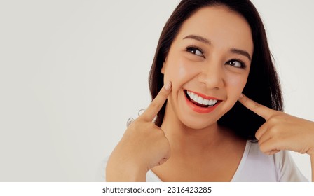Portrait asian woman showing off her beautiful teeth : Young woman's face with healthy teeth white clean beautiful smile : Happy woman taking care of her teeth perfectly : Oral care dentistry 