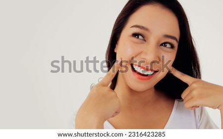 Portrait asian woman showing off her beautiful teeth : Young woman's face with healthy teeth white clean beautiful smile : Happy woman taking care of her teeth perfectly : Oral care dentistry 